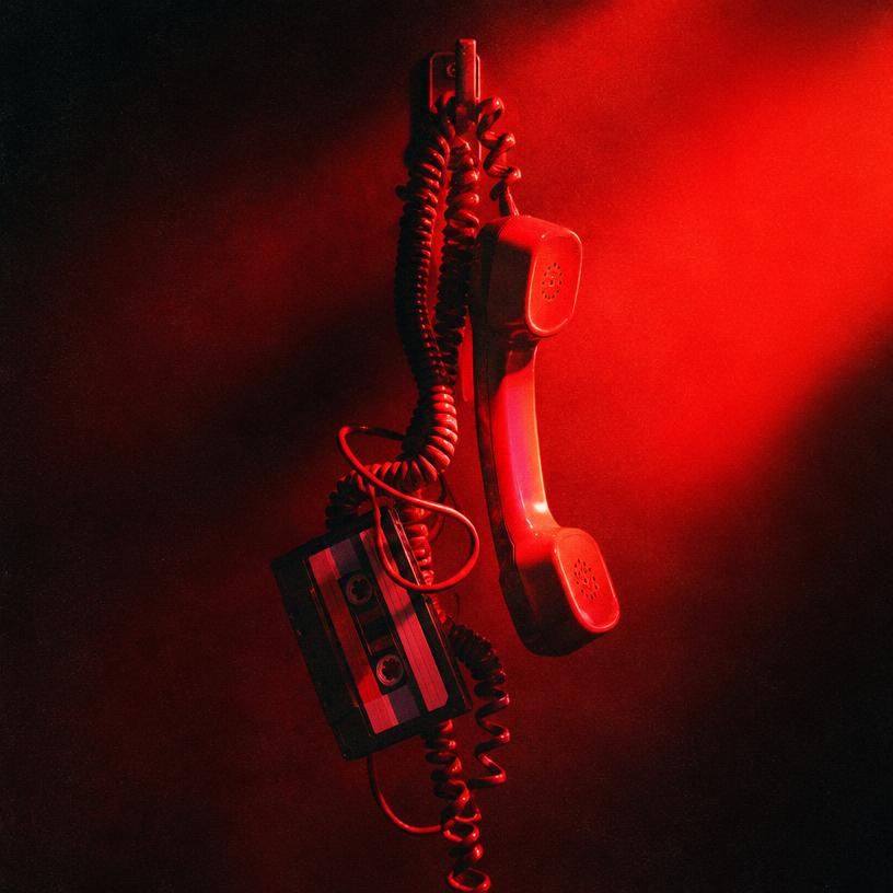 Red-lit telephone handset hanging off the hook